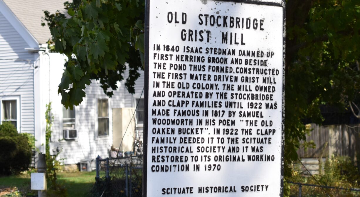 A photograph of a historic sign for a mill.
