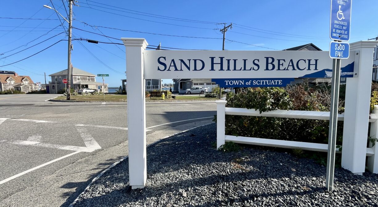A photograph of a property sign on a street corner.
