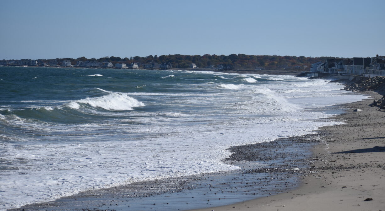 A photograph of an ocean beach with active waves.