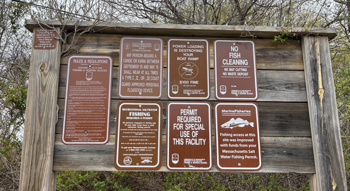 A photograph of a group of signs with property rules.