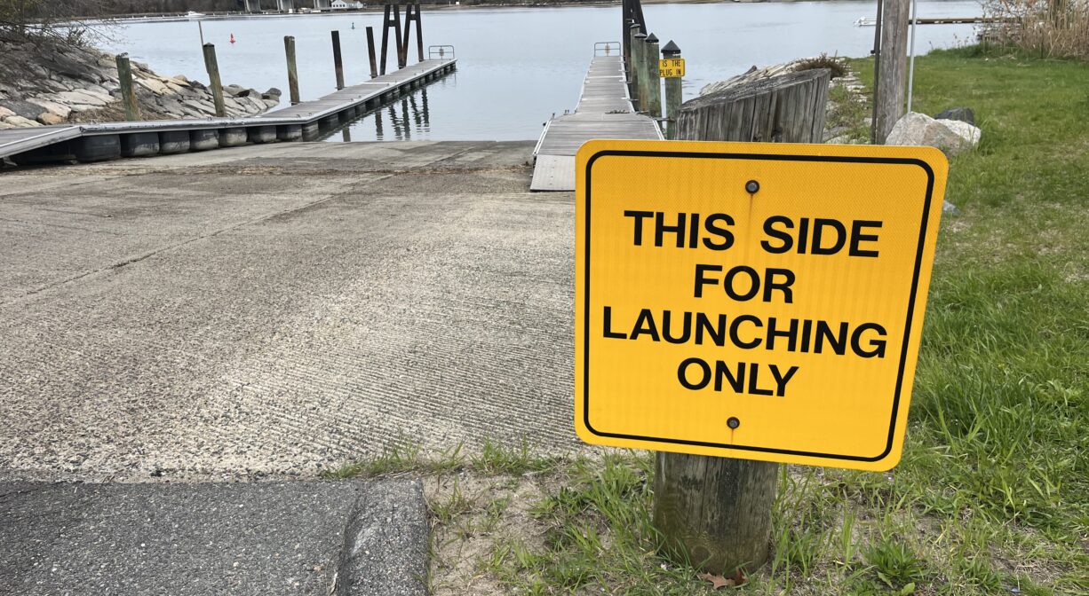 A photograph of a launch ramp with two walkways on a river.