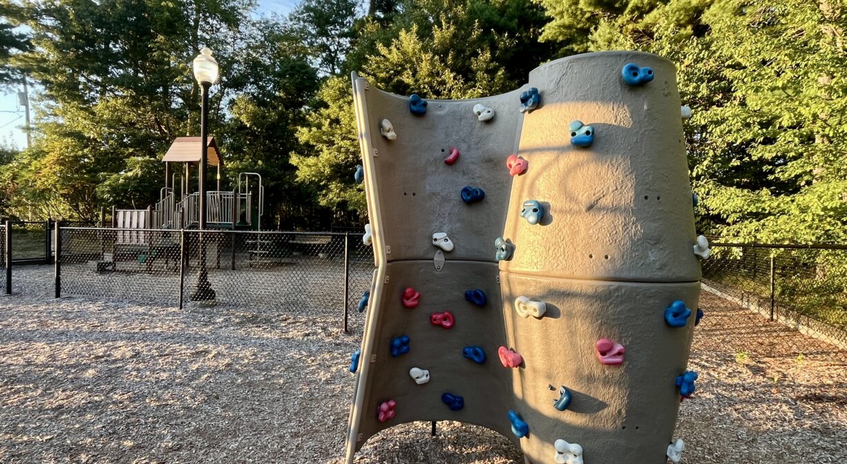 A photograph of a playground with a climbing structure.