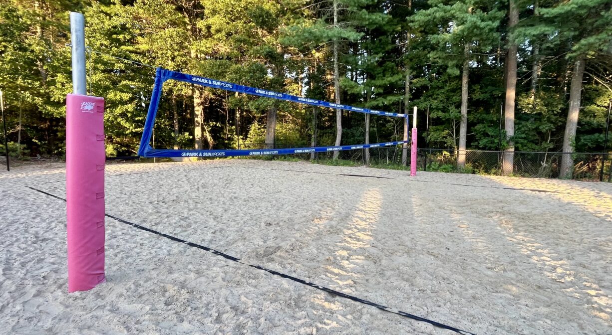 A photograph of a beach volleyball court in a playground.