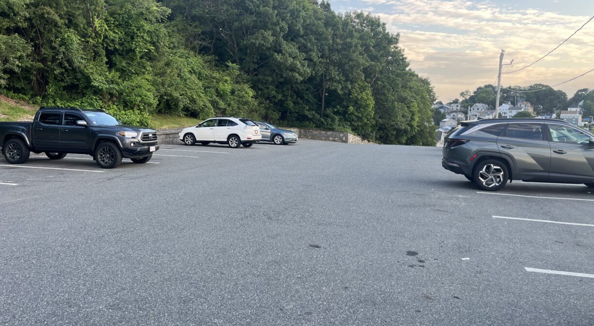 A photograph of a hilltop parking area.