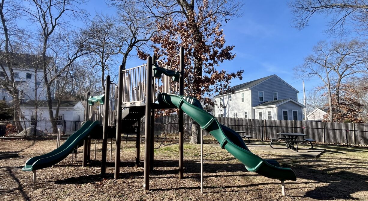 A photograph of a contemporary play structure in a playground.