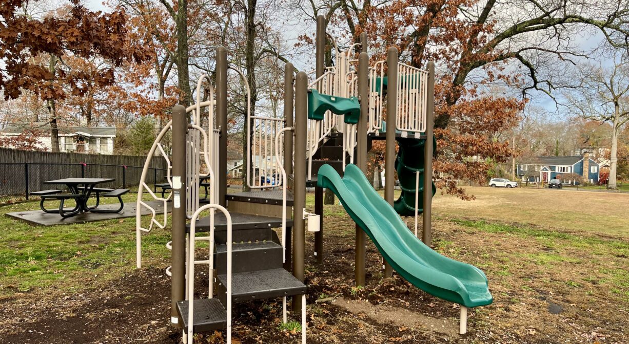 A photograph of a contemporary play structure in a park.