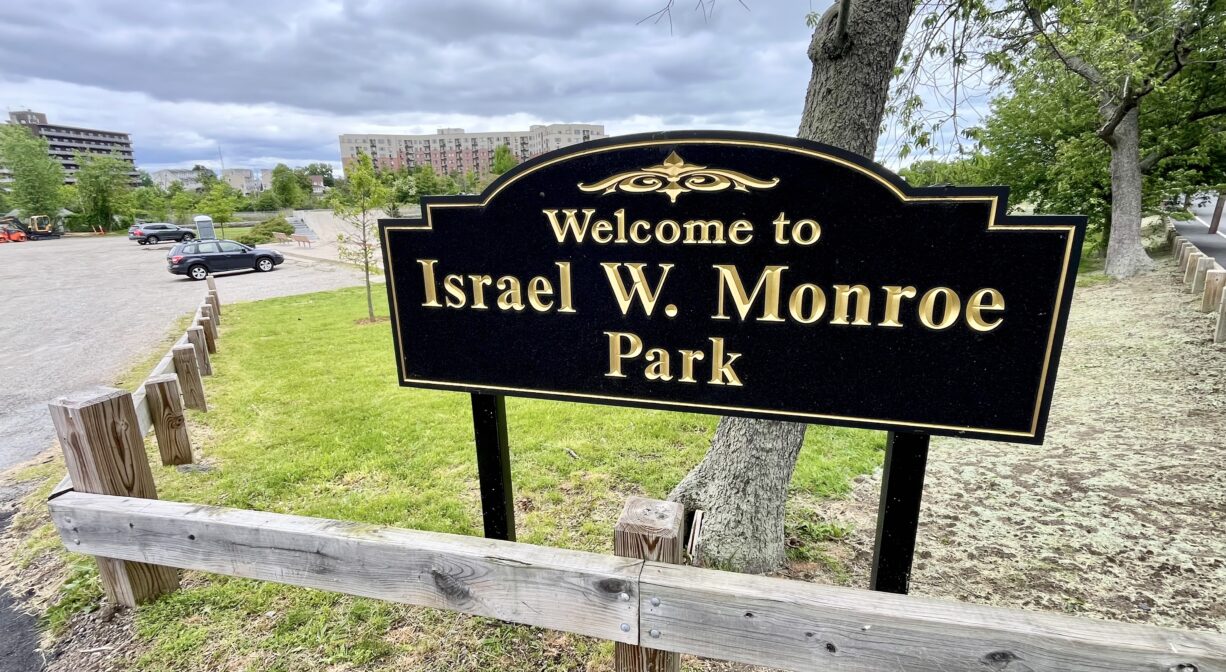 A photograph of a property sign in a park.