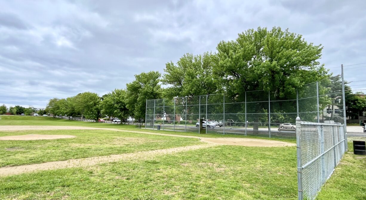 A photograph of a baseball field in a park.