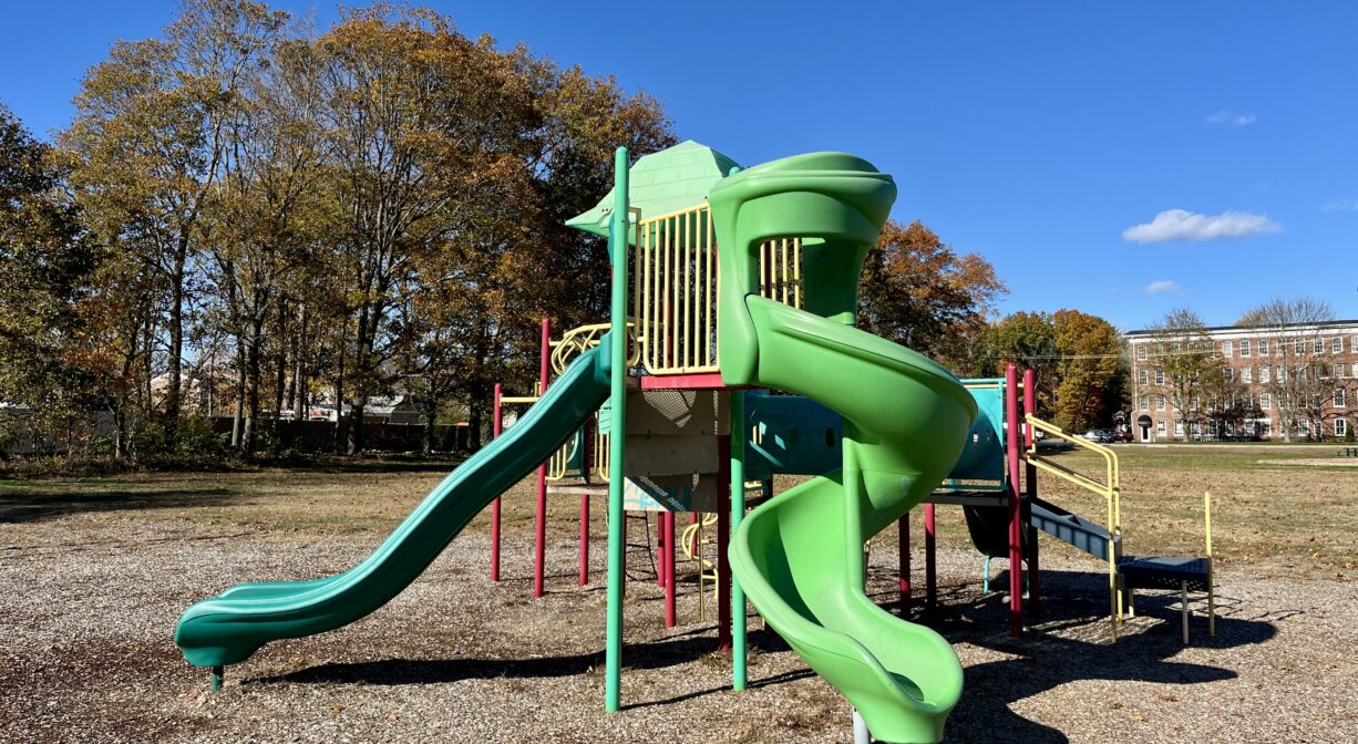 A photograph of a contemporary play structure in a playground.