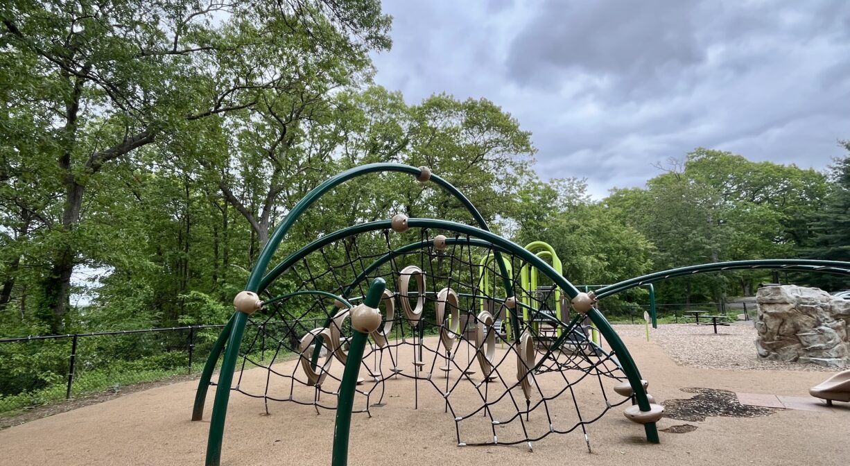 A photograph of a contemporary climbing structure within a playground.