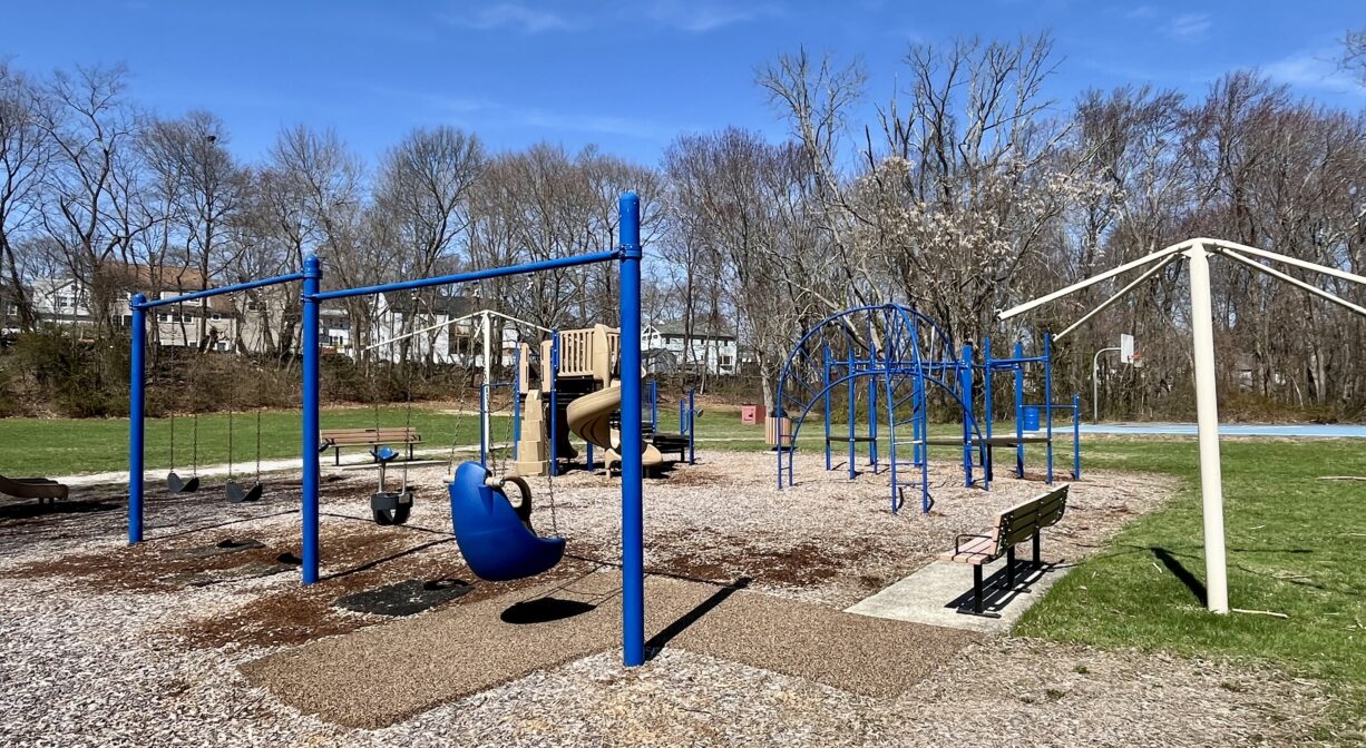 A photograph of a playground with blue play equipment.