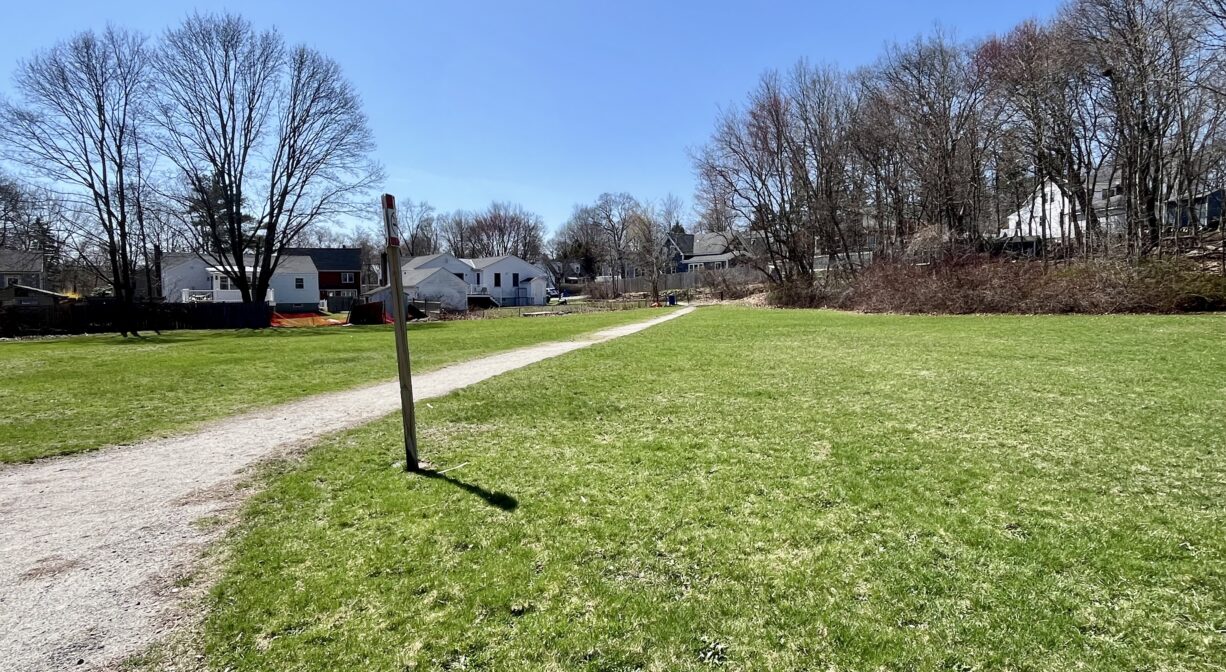 A photograph of an entrance trail in a park.