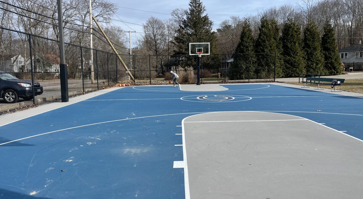 A photograph of a blue and gray basketball court.